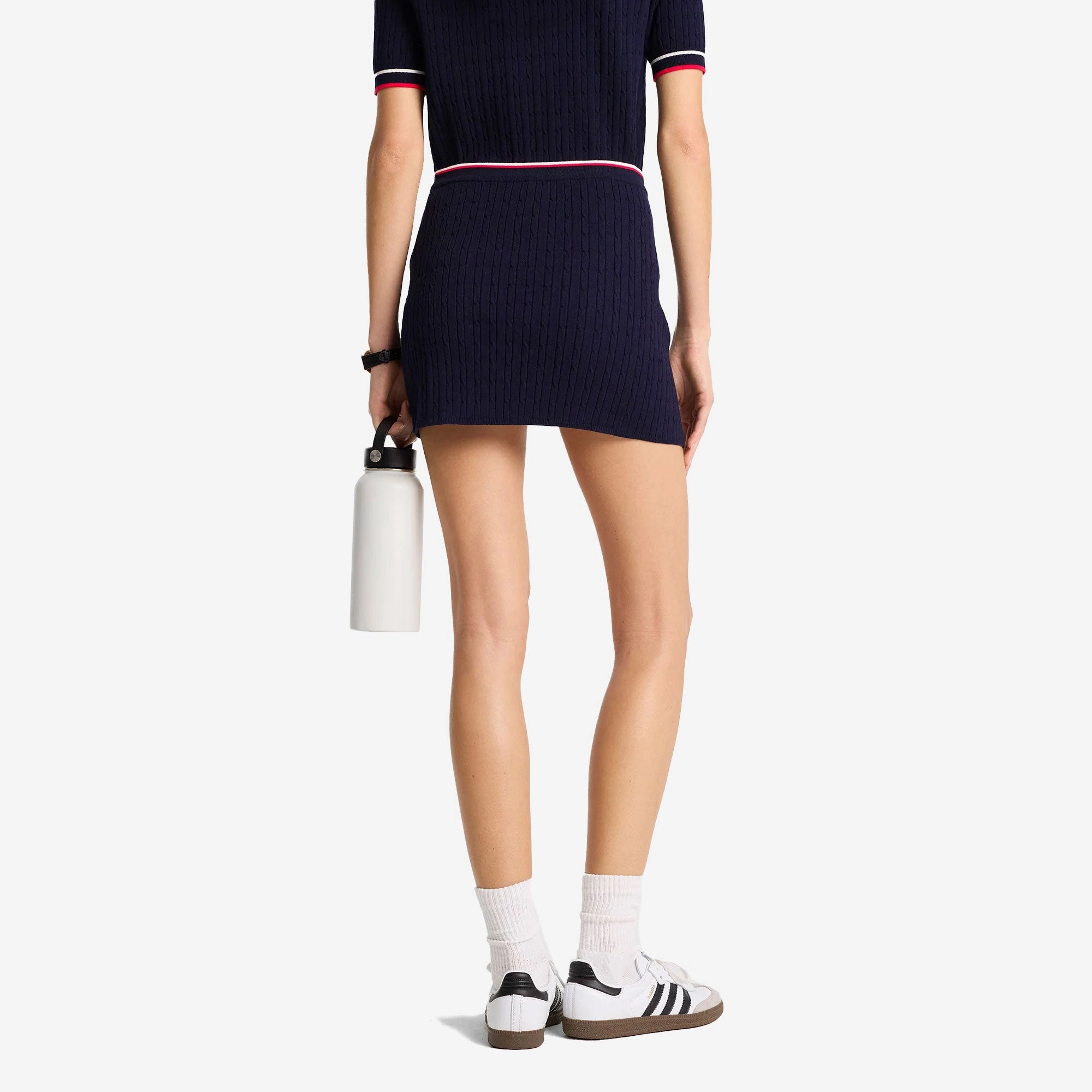 SPORTY & RICH | SERIF LOGO MINI CABLE SKIRT { NAVY
